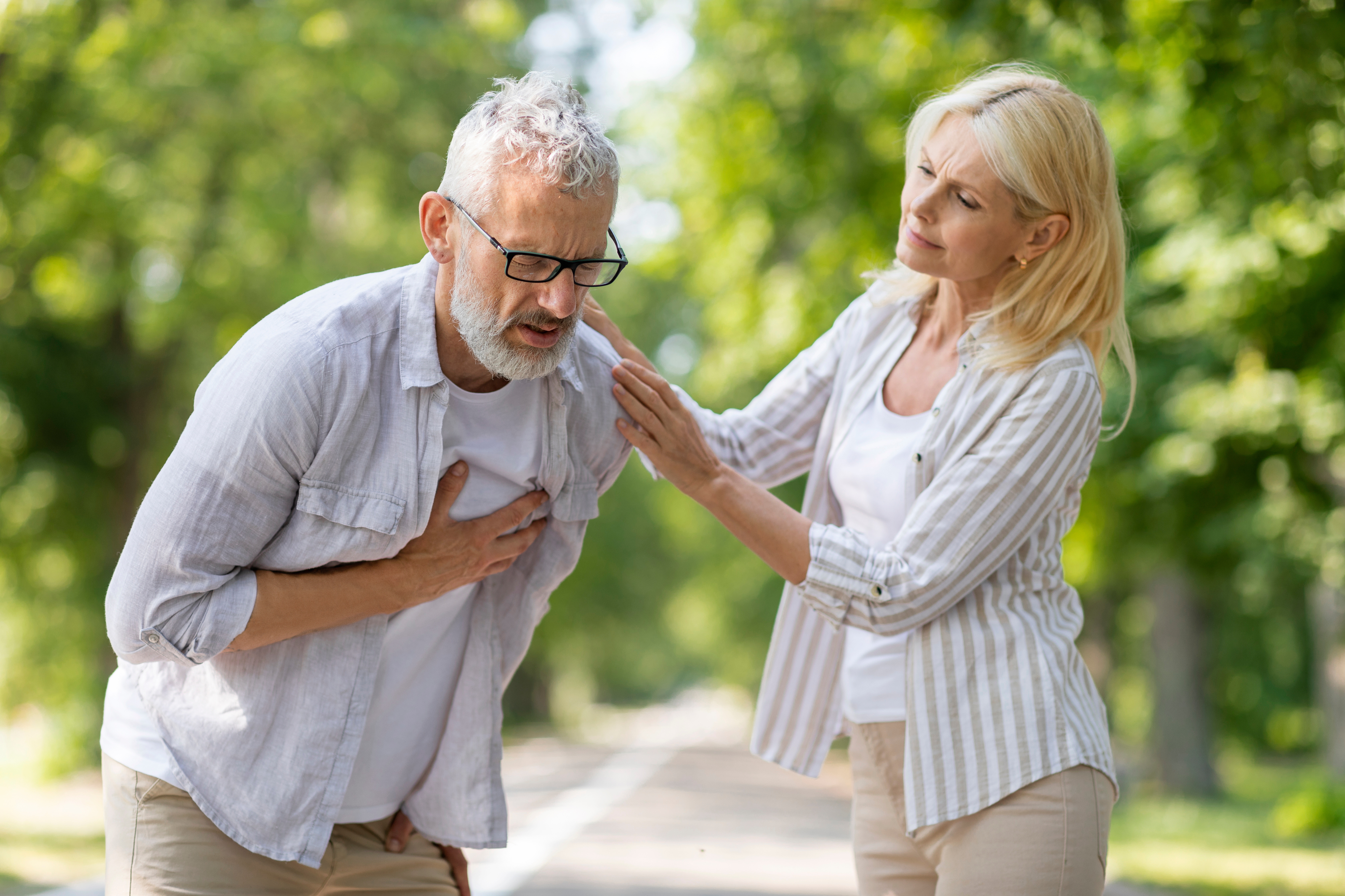 man clutching heart in pain